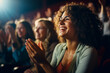 © Keitma - Woman in a audience in a theater applauding clapping hands. cheering and sitting together and having fun