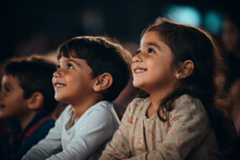 Side View Of A Children Audience Enjoying A Kids Concert Or Movie With Happy Smiling Faces