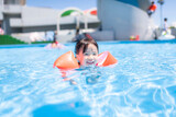 夏休みにプールで遊ぶ小さな女の子