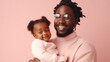 © iuricazac - A heartwarming moment captured in the studio as a loving Afro dad gently holds his smiling baby. Generative AI