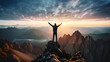 Man on top of a mountain with arms raised, winner of mountain summit concept