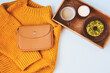 © mashiki - cozy autumn morning flat lay composition with warm sweater, cup of coffee, sweet donut for breakfast and fashion handbag