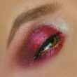 Cherry red make-up with close-up of a woman's eye with shimmer finish, Christmas makeup look