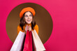 Leinwandbild Motiv Photo of cheerful pretty lady peek out pink hole look up empty space total sale low prices limited time isolated on beige color background