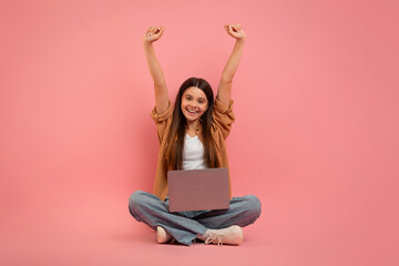 Wall Mural - Happy Teen Girl With Laptop Celebrating Success On Pink Background