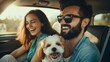 Happy couple during car trip on vacation together with their dog