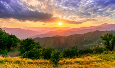 summer scenery mountain view from a highland hill to a beautiful sunset.