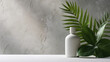 © Свет Лана - A bottle of body care cosmetics on a gray background with green leaves.