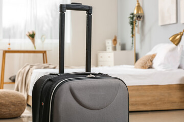 Poster - Black suitcase in light bedroom, closeup