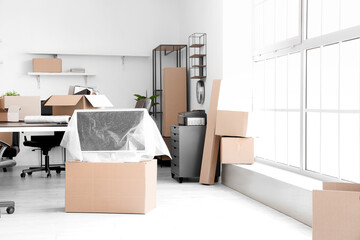 Poster - Interior of light office with cardboard boxes on moving day