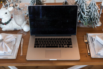 Christmas decorated working space with a laptop on the desk, social media holiday concept with blank space for a text