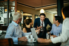 Group Of Business People Having A Meeting In A Cafe Bar