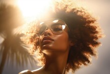A Woman With Curly Hair Wearing Sunglasses