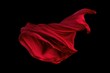Captivating Red Fabric in Mid-Air: A Stunning Display of Movement and Texture on a Dark Background