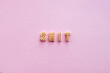 © Clique Images - Close-up view of alphabet pasta forming word ‘shit’ against pink background