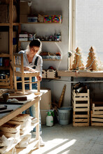Female joiner in woodworking studio