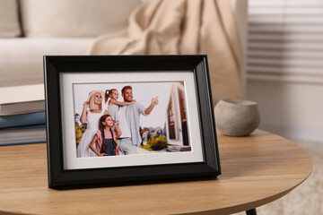 Sticker - Frame with family photo on wooden coffee table in room, space for text