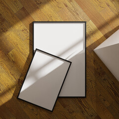 set of two with duifferent size aesthetic frame mockup poster laying on the wooden floor lit by sunlight