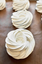 Close-up View Of Uncooked Meringue Nests On Baking Sheet   