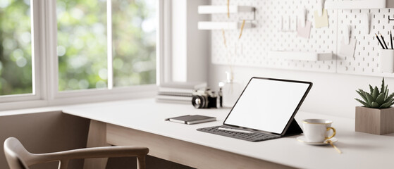 Wall Mural - A tablet with a wireless keyboard on a white table in a minimal white home workspace.