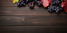 Black Juicy Grapes On Dark Wooden Background.