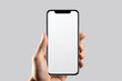 © Akmalism - Phone mockup in hand - clipping path, Studio shot of smartphone with blank white screen for web site design, app for mobile phone and advertisement.