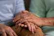 © WESTOCK - Close up shot of mother consoling to daughter by taking and holding her hands at home - concept of Caring Support, Comforting Gesture and Parental Love or care
