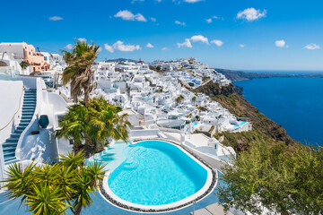 Wall Mural - White architecture in Santorini island, Greece. Luxury swimming pool with sea view.