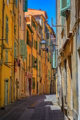 Poster - Picturesque narrow streets with colorful traditional houses in the old town of Menton, French Riviera, South of France