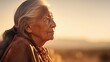 Leinwandbild Motiv Old senior native american woman close-up portrait with wrinkles skin on golden sunset, outdoors in America nature. Indigenous people of first nation of americas
