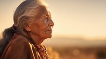 Old Senior Native American Woman Close-up Portrait With Wrinkles Skin On Golden Sunset, Outdoors In America Nature. Indigenous People Of First Nation Of Americas
