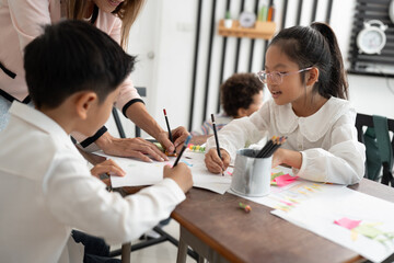 Student Asia kid girl studying with friend and teacher in classroom	