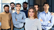 © Katsiaryna - Successful millennial business woman stands at the forefront of a multiethnic team