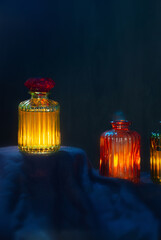 Wall Mural - magic glowing  potions in glass bottles on dark background