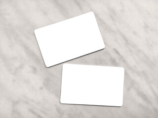 Double-sided business card template with rounded edges on a gray marble background. Business card mockup. Two white or transparent frames with copy space