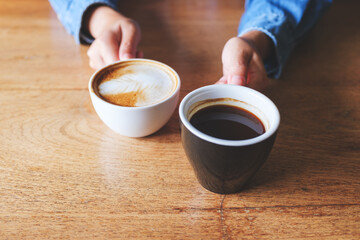 Poster - Closeup image of a woman holding and serving two cups of hot coffee