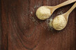 Top view two spoons of brown sweet  sugar  on wooden table with copy space.