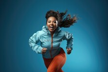Overweight African Woman Running In A Tracksuit On Ligth Blue Backgound. Сoncept Healthy Weight For African Women, Benefits Of Running, Tracksuits As Exercise Gear