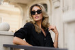 © Svetlana Sokolova - Elegant luxury blond woman with perfect wavy hairs , make up , sunglasses posing outdoor. Casual outfit.