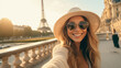 © ArgitopIA - Young influencer girl taking a selfie with the Eiffel Tower in the background