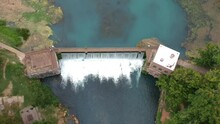 Skyview Of A Rushing Water Thru A Dam From Drone Angle Looking Down From Very High