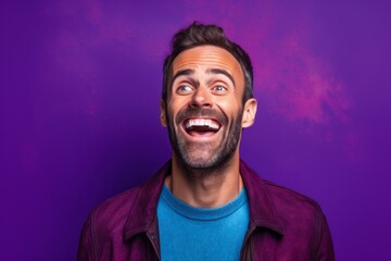 Wall Mural - Lifestyle portrait photography of a grinning boy in his 30s covering his mouth against a vibrant purple background. With generative AI technology