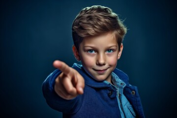 Wall Mural - Headshot portrait photography of a tender boy in his 30s pointing with two hands and fingers to the side against a deep indigo background. With generative AI technology