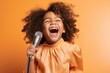 Medium shot portrait photography of a glad kid female dancing and singing song in microphone against a pastel orange background. With generative AI technology