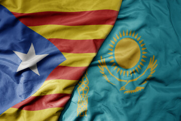 big waving national colorful flag of catalonia and national flag of kazakhstan .