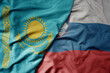 big waving national colorful flag of kazakhstan and national flag of slovenia .