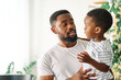 © Lumos sp - child family portrait father happy son man boy black american african smiling happiness love together parent cute hug kid little