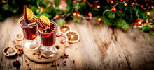 Top View Of Pair Of Glasses With Aromatic Mulled Wine Standing On Wooden Background