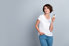 Photo Of Pretty Minded Creative Person Hold Apple Iphone Gadget Look Empty Space Isolated On Grey Color Background