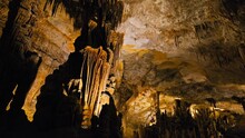 An Underground Cave Formed Of Carbonate Limestone Rocks In Majorca, Spain. A Colourful Natural Scenery In A Cave With Ancient Cavities Of Stalactites And Stalagmites On Mallorca, Balearic Islands.